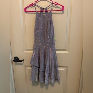 sparkly silver sleeveless dress with a halter-style neckline.